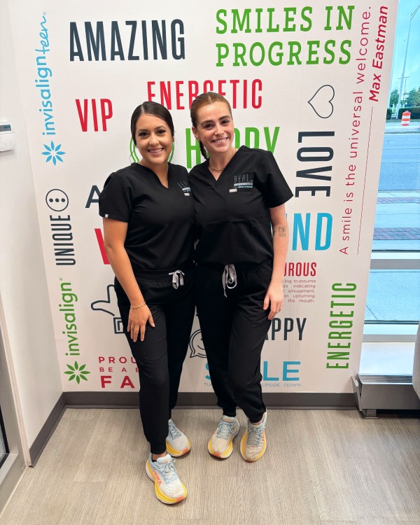 Two Behl Orthodontics assistants sharing a smile