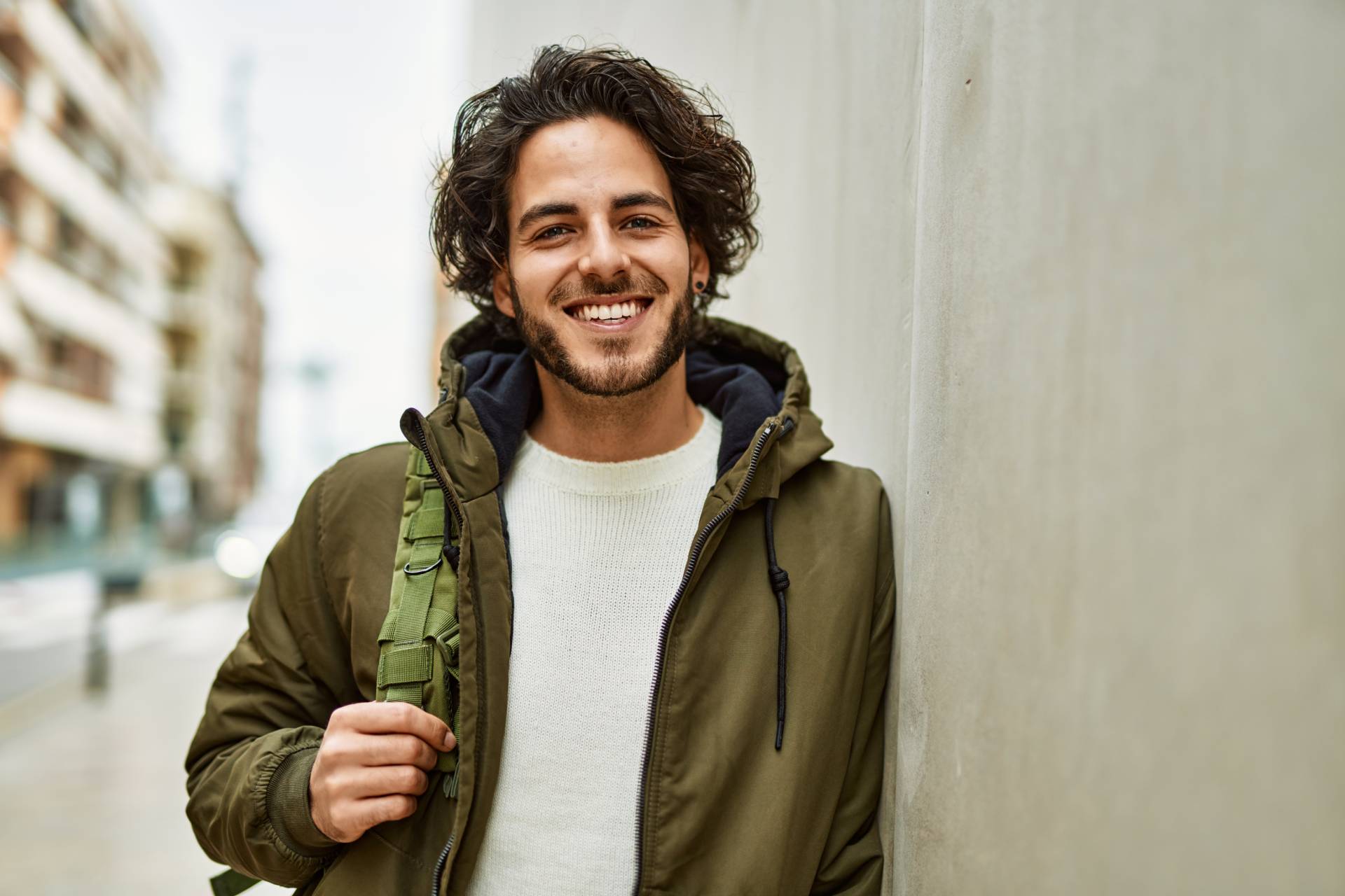 Young man smiling confidently at Behl Orthodontics