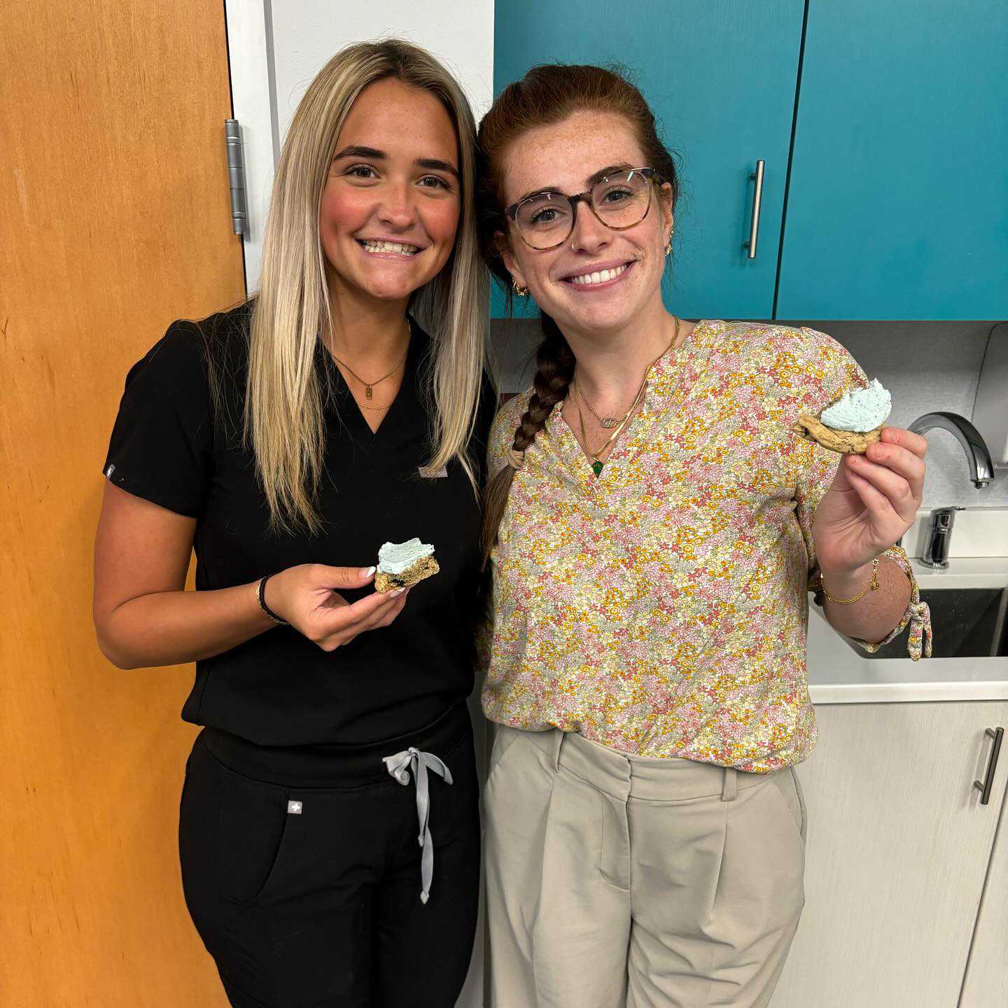 Two Behl Orthodontics assistants sharing a sweet treat