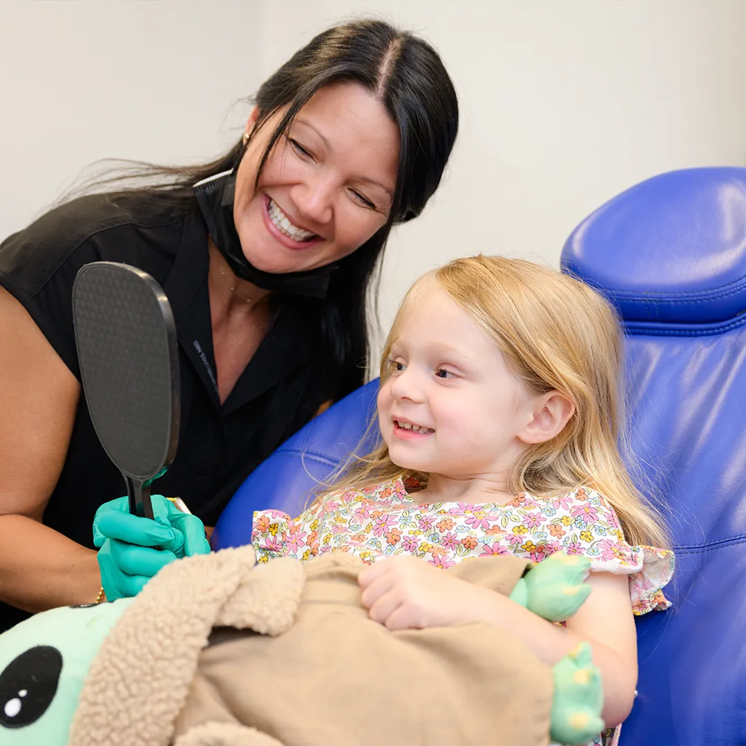 Patient checking progress with assistant at Behl Orthodontics