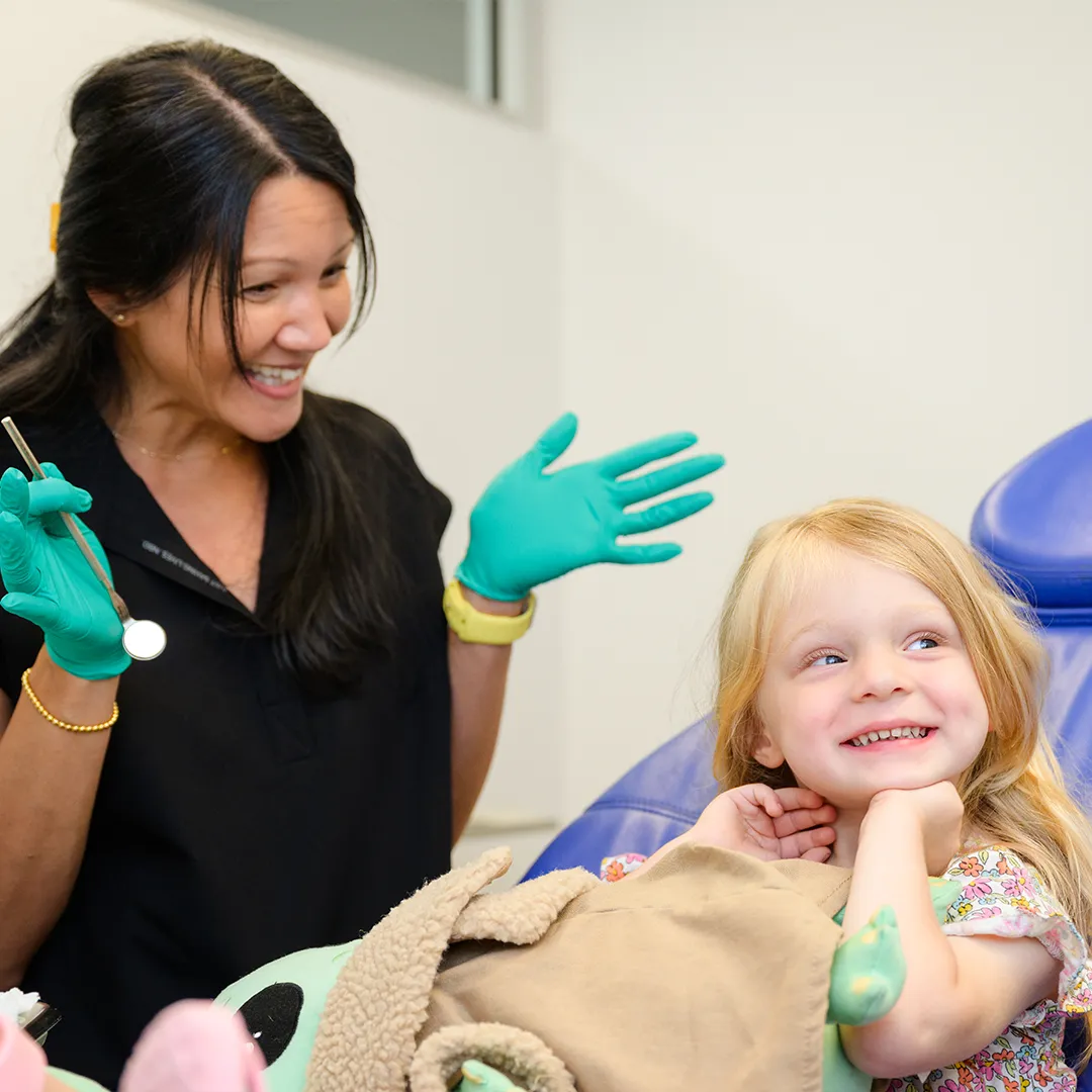 Caring orthodontic assistant comforting a young patient at Behl Orthodontics