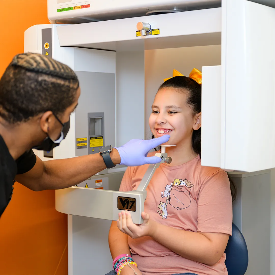 Behl Orthodontics assistant taking photos of a patient before braces